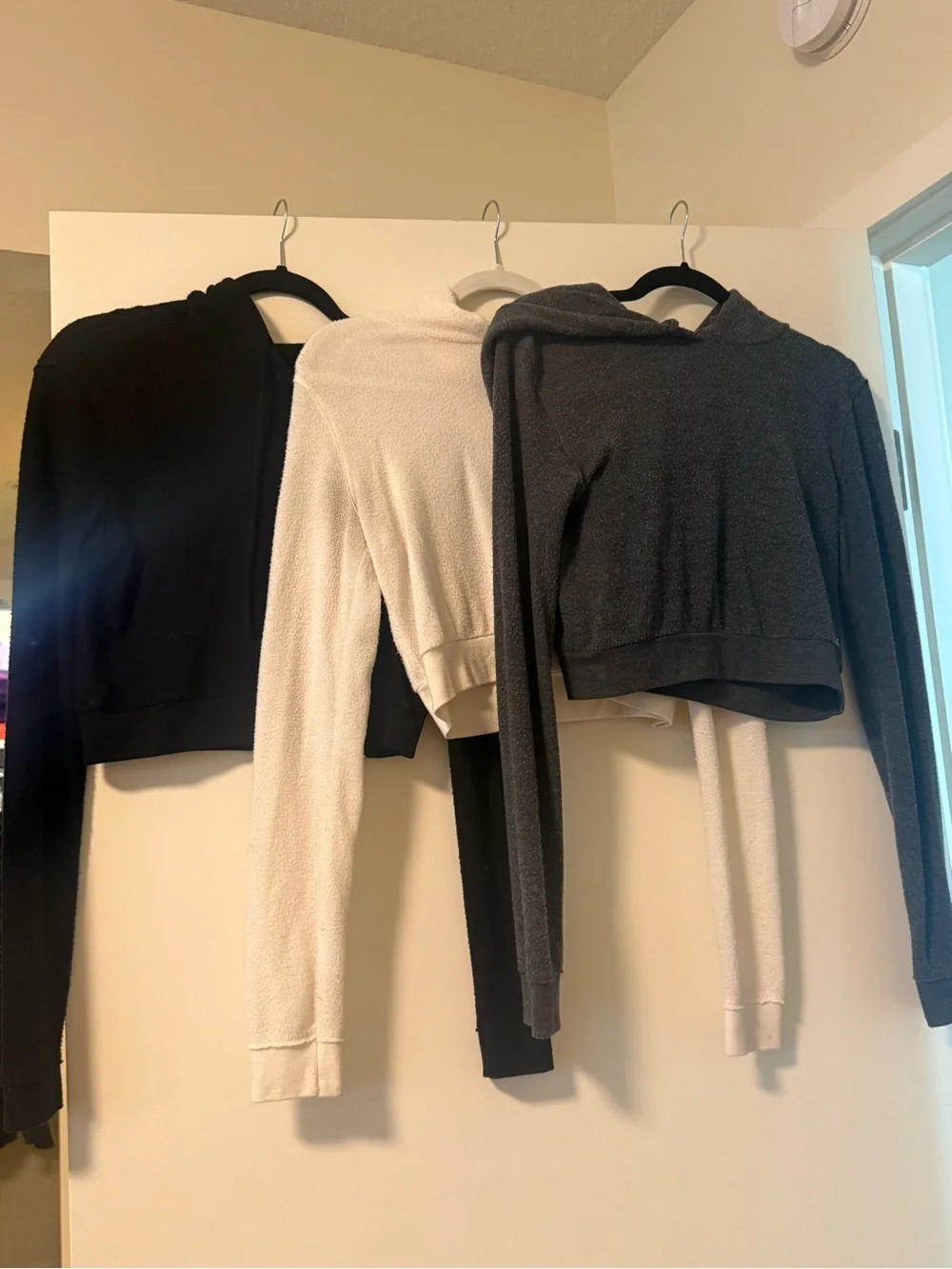 ALO Yoga Cozy Cropped Hoodies in Black, Cream, and Charcoal